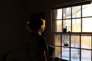 woman contemplating at window